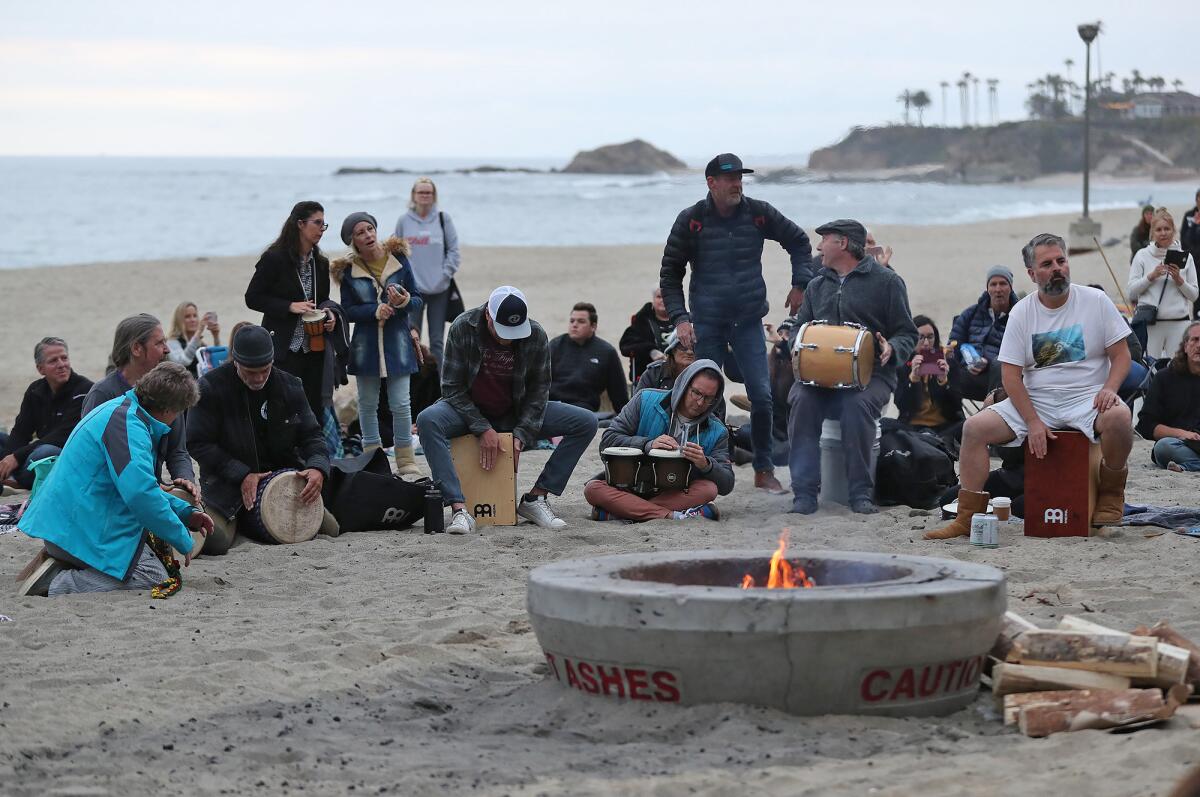 Community members gather around a fire pit for a drum circle in 2022.