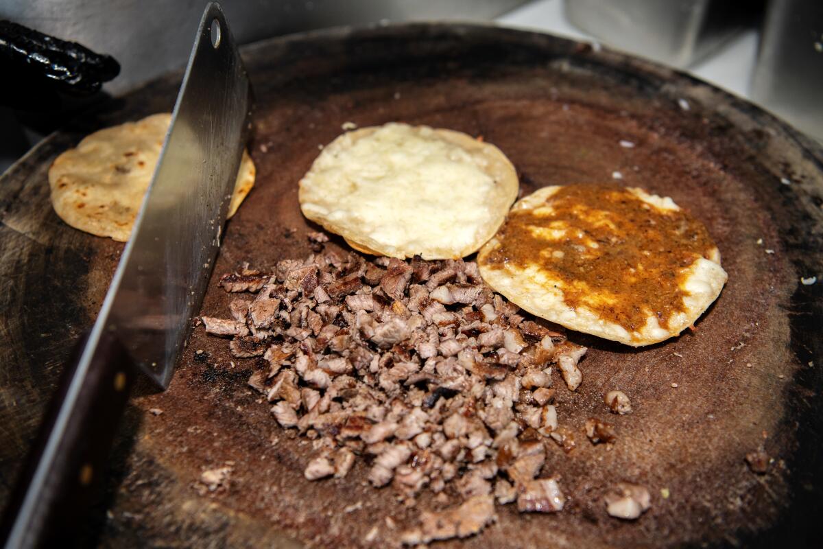 LONG BEACH, CA - OCTOBER 16: Scenes from inside Tacos La Carreta as dishes are prepared on Monday, Oct. 16, 2023 in Long Beach, CA. (Mariah Tauger / Los Angeles Times)