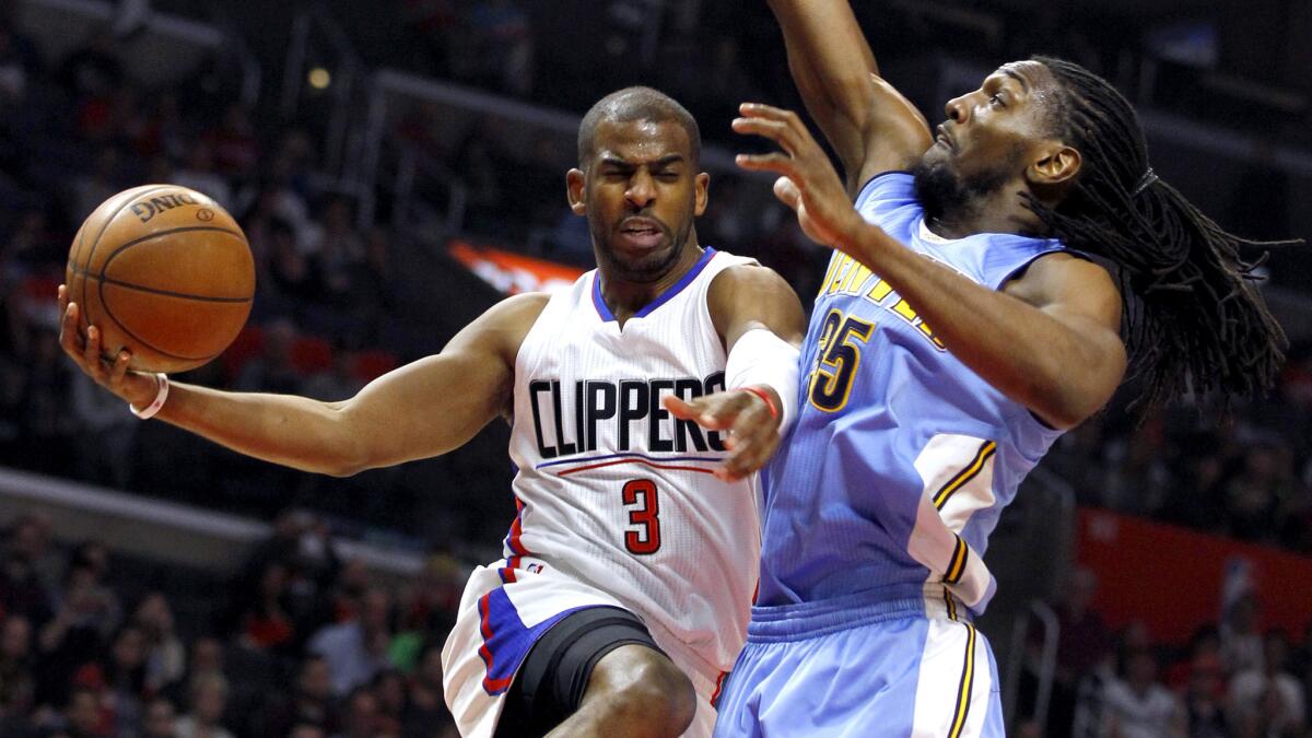 Clippers point guard Chris Paul drives to the basket along the baseline against Nuggets forward Kenneth Faried during their game Wednesday.