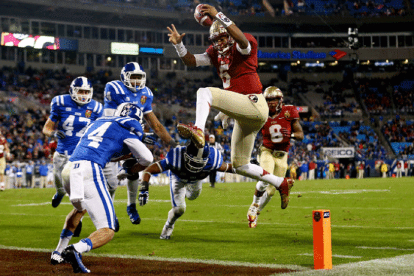 Florida state quarterback Jameis Winston rushes for a touchdown against Duke during the ACC championship game Saturday at Bank of America Stadium.