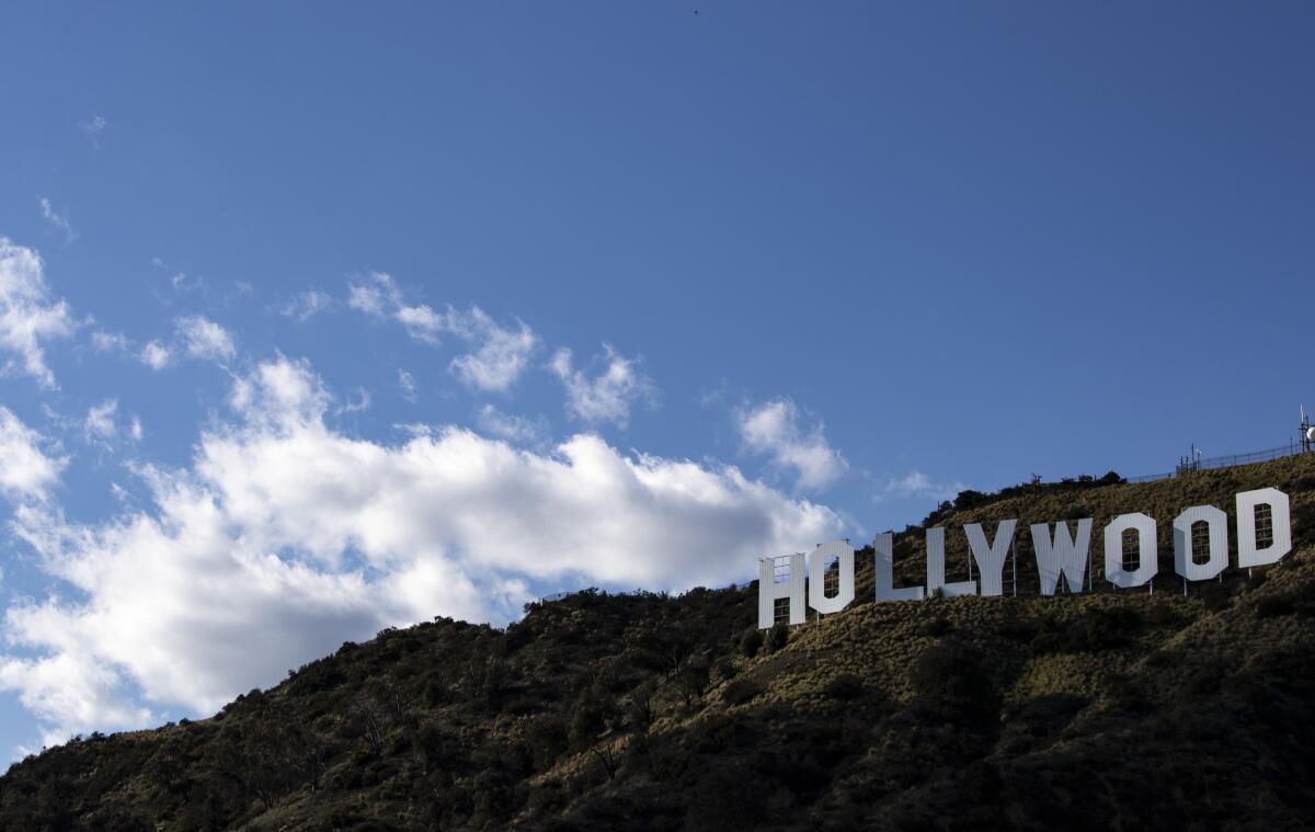 Clouds drift over the Hollywood sign in Griffith Park in Los Angeles