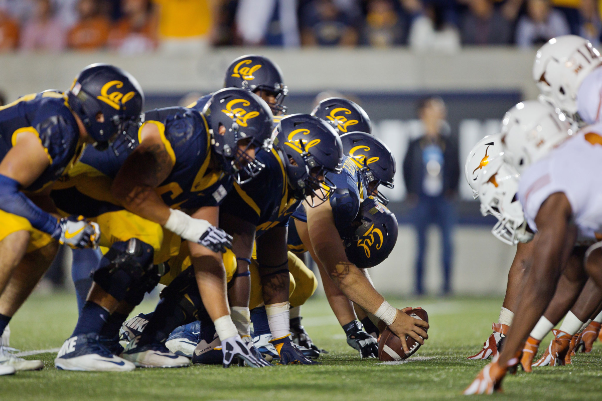 California prepares to kick an extra point against Texas.