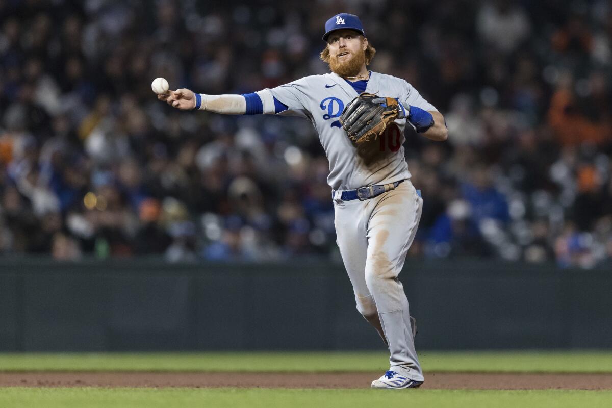 Dodgers third baseman Justin Turner throws during a 6-1 win over the Giants on Saturday.