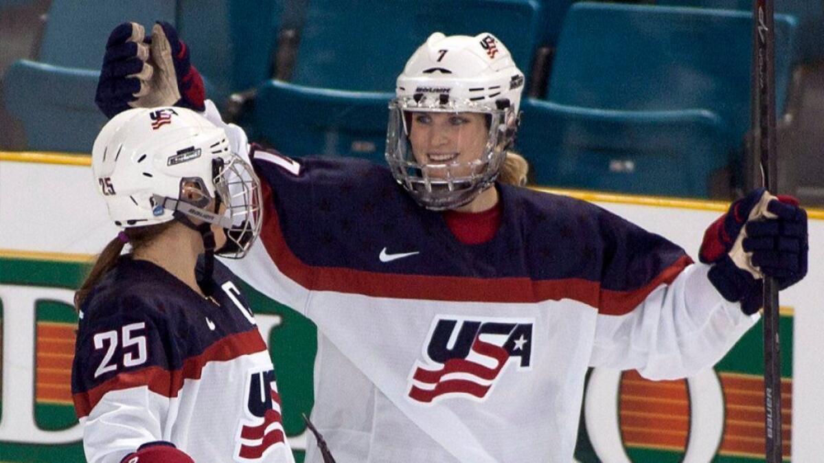 Team USA's Monique Lamoureux, right, celebrates her goal against Team Finland with teammate Alex Carpenter during the Four Nations Cup in Kamloops, British Columbia on Nov. 4, 2014.