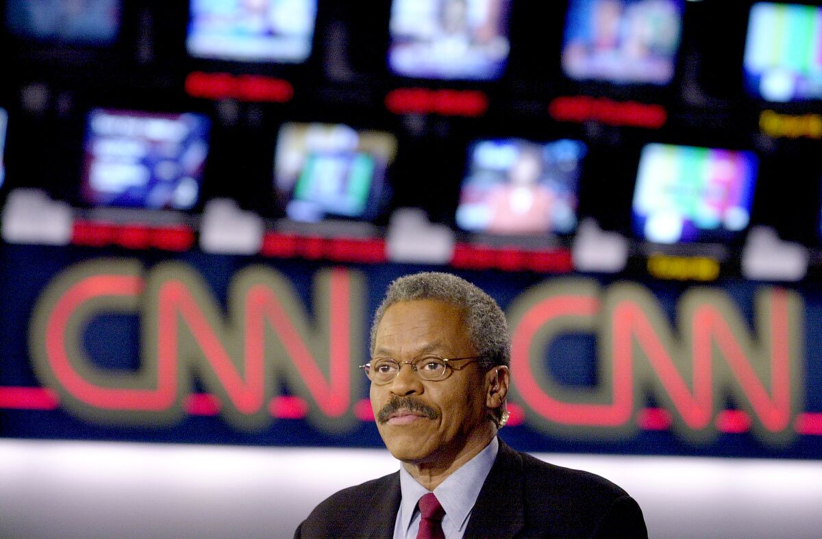 A news anchor wearing glasses appears with a CNN logo behind him
