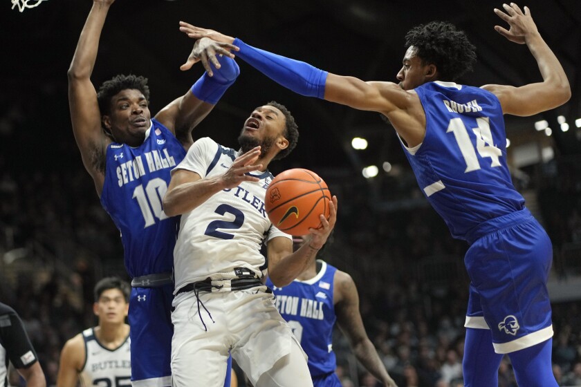 Butler guard Aaron Thompson (2) shooots between Seton Hall defenders Alexis Yetna (10) and Jared Rhoden (14) in the first half of an NCAA college basketball game in Indianapolis, Tuesday, Jan. 4, 2022. Seton Hall won 71-56. (AP Photo/AJ Mast)