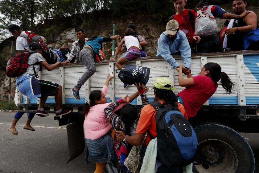 Mandatory Credit: Photo by Esteban Biba/EPA-EFE/REX (9936339e) Honduran immigrants of the caravan heading to Mexico get on trucks to Guatemala City, in Zacapa, Guatemala, 17 October 2018. The caravan of Honduran immigrants of around three thousand people, according to the UN, continues its itinerary in Guatemala with the aim to reach the United States. The Honduran immigrants caravan advances in Guatemala, Zacapa - 17 Oct 2018 ** Usable by LA, CT and MoD ONLY **