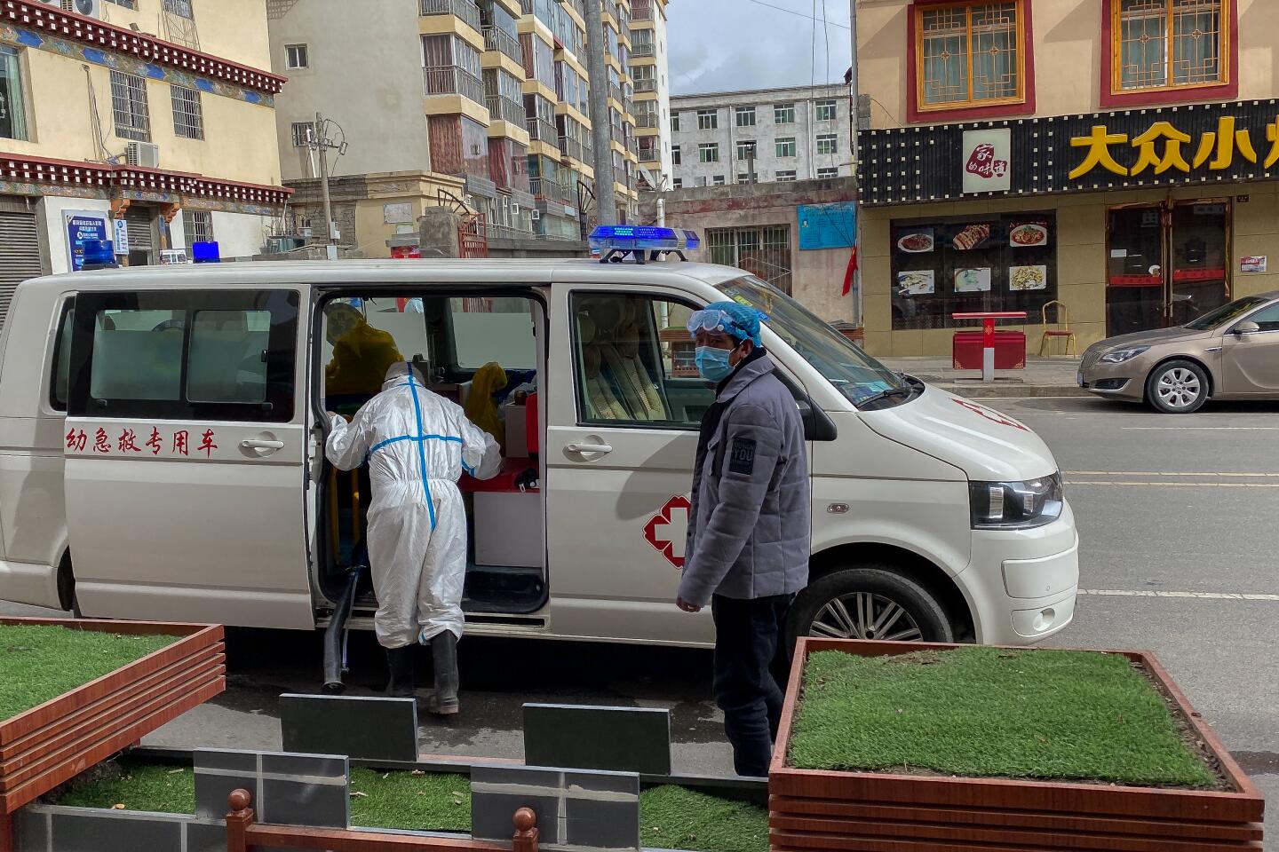 A sanitation vehicle driving around Garze on Feb. 2, 2020. The workers in the vehicle wore protective gear and broadcast instructions about virus prevention in Mandarin through loudspeakers as they went around the city.