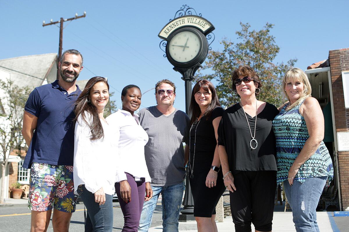 The "Kenneth Village People", a name the group just came up with and giggled about, includes, from left, Chris Cragnotti, Pilar Molina, Jackie Bartlow, Cliff Claycomb, Tonya Lariviere, Jerri Cragnotti, and Kandice Astamendi. The group stands in front a clock on Kenneth Road in the Kenneth Village area of Glendale on Friday, October 9, 2015. The group is using a "Go Fund Me" site to raise money to restore and repair historic features in the village, including the clock, a banner, street lights and the village's website.