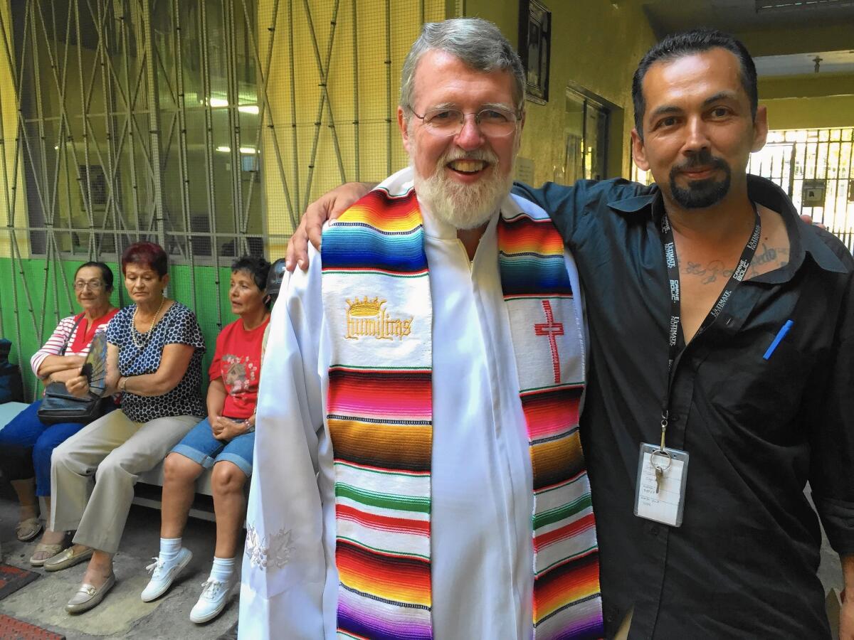 Casa del Migrante Director Father Patrick Murphy, 63, with Juan Carlos Garcia Aguilar, 39, of Bakersfield, who was deported to Mexico after serving a drug sentence. His five children are in Bakersfield.