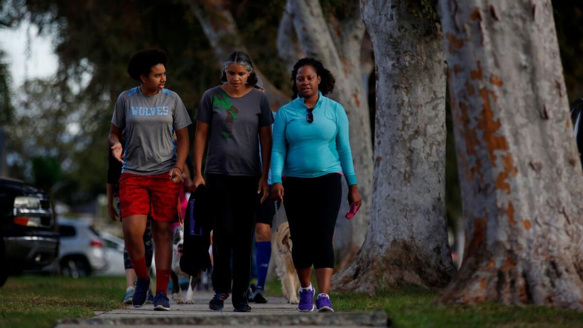 From left, Moreau Halliburton, Monique Marshall and Mikaela Randolph walk together in Leimert Park.