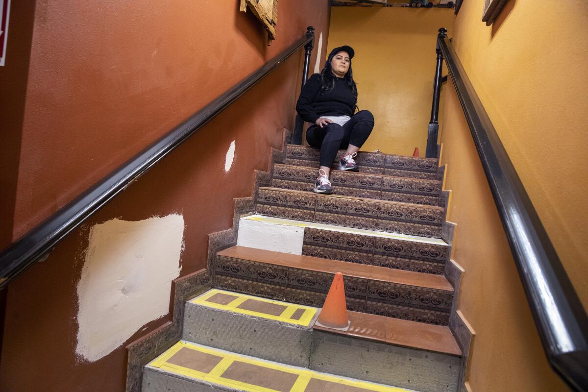 Monica Ramirez, president of La Blanquita, sits at the top of a stairwell