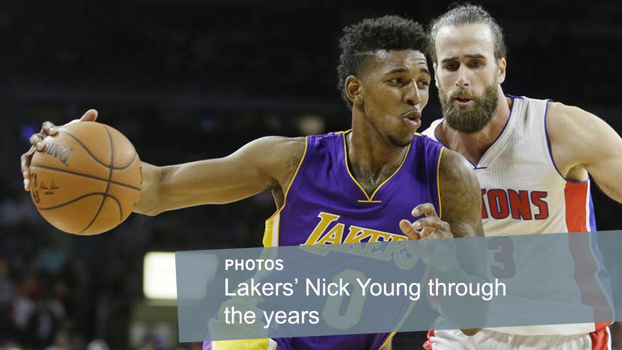 Lakers small forward Nick Young drives past Detroit forward Luigi Datome during a Lakers' victory on Dec. 2, 2014, in Auburn Hills, Mich. Young, a Los Angeles native, was a star at USC and has been a standout for the Clippers and Lakers during his pro career.