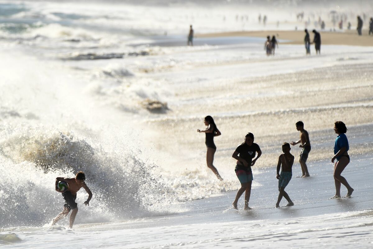 Children play in the surf on Zuma Beach.