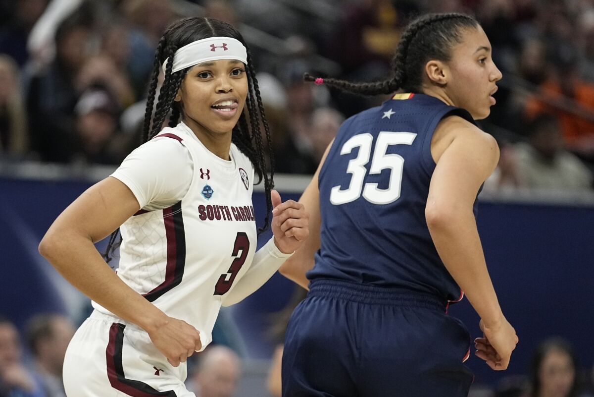 South Carolina's Destanni Henderson smiles after making a basket during the second half of a college basketball game in the final round of the Women's Final Four NCAA tournament Sunday, April 3, 2022, in Minneapolis. (AP Photo/Eric Gay)