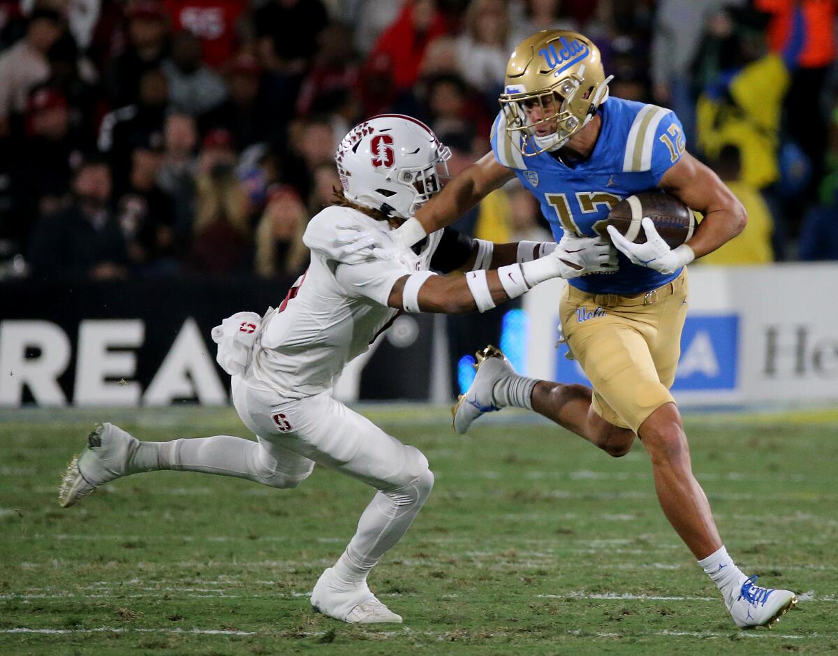UCLA wide receiver Matt Sykes makes a catch in front of Stanford cornerback Nicolas Toomer.