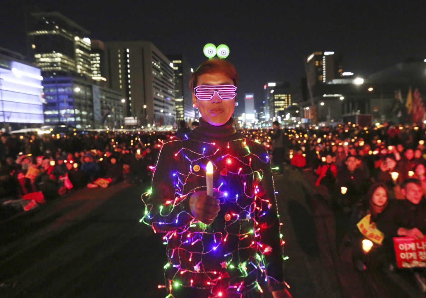 A protester with lights attached to his clothing attends a rally Friday calling for Park Geun-hye's arrest.