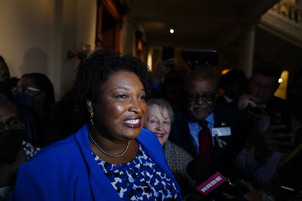 FILE - Georgia gubernatorial Democratic candidate Stacey Abrams talks to the media after qualifying for the 2022 election on Tuesday, March 8, 2022, in Atlanta. Abrams’ campaign told a federal judge in a hearing on Monday, April 11, 2022, that it should be allowed to raise and spend unlimited sums immediately under Georgia law. (AP Photo/Brynn Anderson, File)