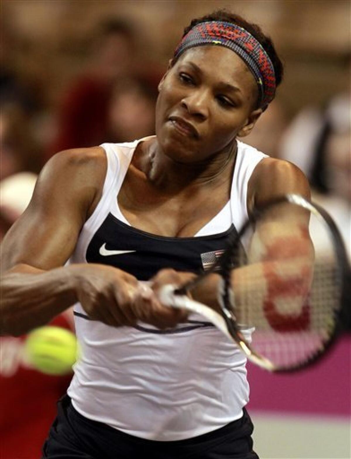Serena Williams returns a ball to Anastasia Yakimova, of Belarus, during a first-round Fed Cup tennis match in Worcester, Mass., Sunday, Feb. 5, 2012. (AP Photo/Steven Senne)
