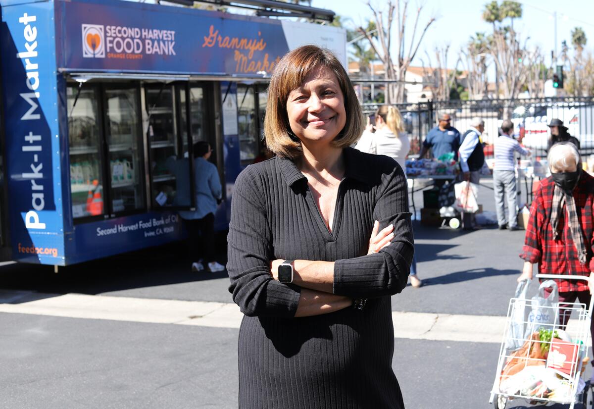 Claudia Keller Bonilla, the chief executive of Second Harvest Food Bank, stands in front of the mobile market.