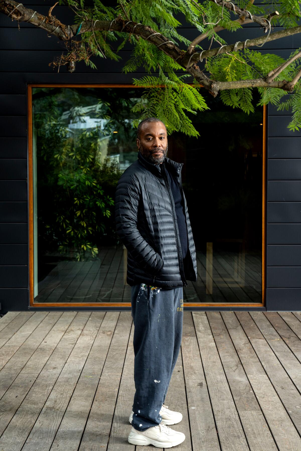 Director Lee Daniels in a puffy coat and sweatpants standing on his deck