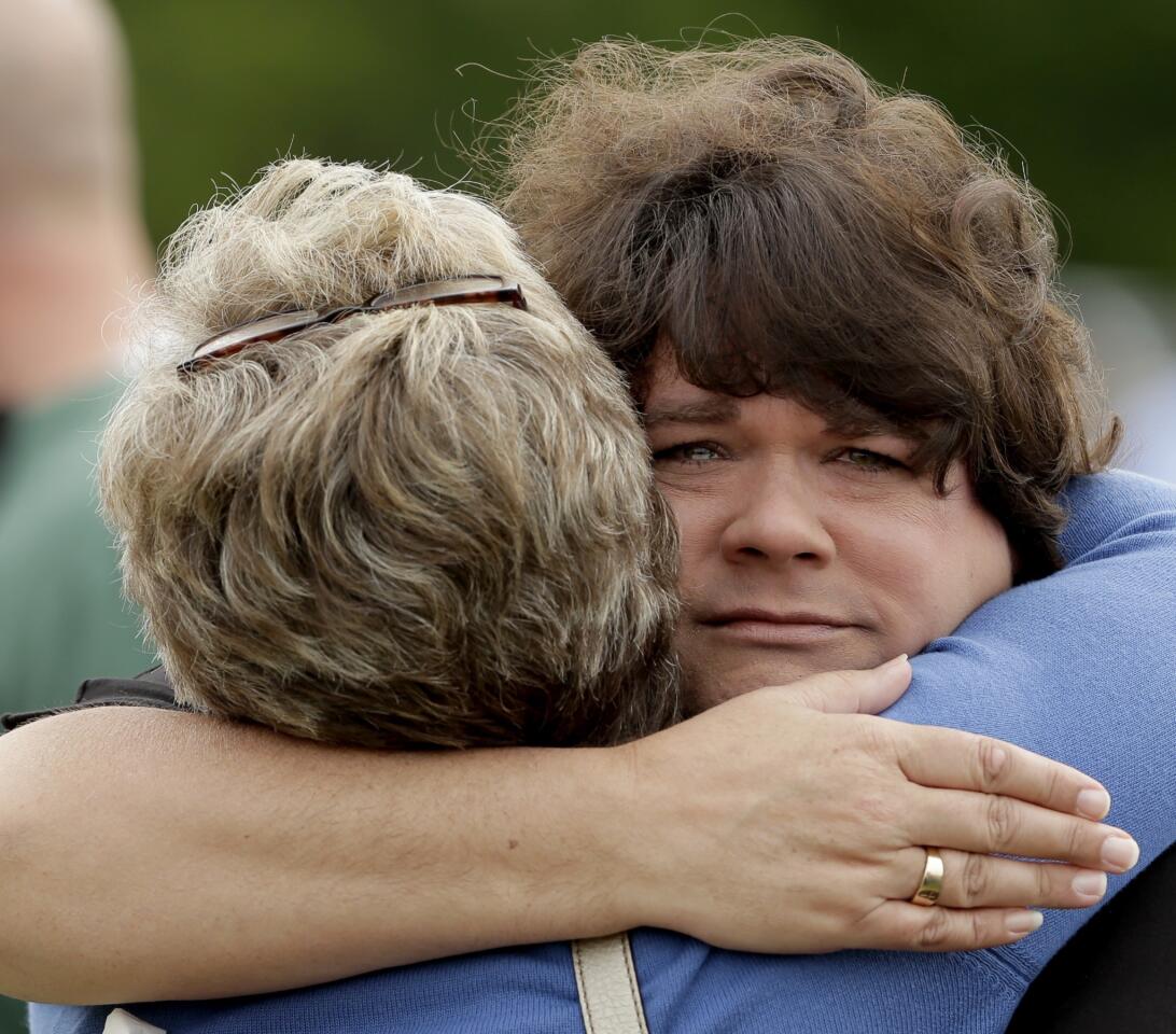 Lisa Crowder, facing camera, is hugged by a friend before a First Baptist Church service held in a field four days after an explosion at a fertilizer plant in West, Texas. Crowder's home was destroyed in the massive explosion.