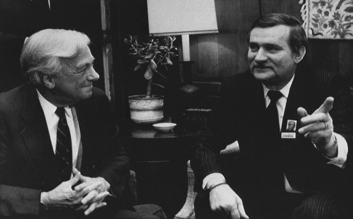 The late John C. Whitehead, left, meeting with Solidarity leader Lech Walesa in 1988: You won't be reading much about how he cost the Getty Trust $400 million.