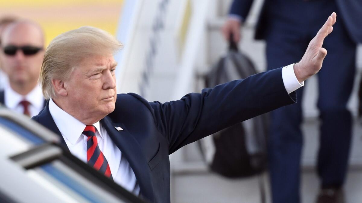 President Trump waves upon arriving in Helsinki on Sunday.