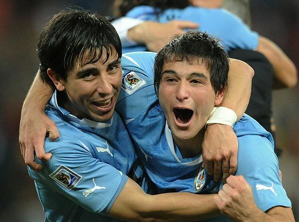 Uruguay's defender Jorge Fucile, left, and midfielder Nicolas Lodeiro celebrate after the team's quarterfinal win over Ghana at Soccer City stadium in Soweto, South Africa. Uruguay won 4-2 on penalty shots.