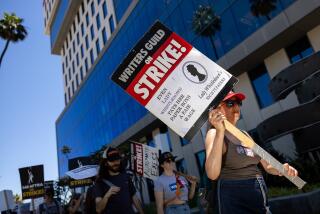 Hollywood, CA - July 26: Someone carried a sign with an image referencing Netflix's period-show, "Bridgerton," with the statement, "Even Lady Whistledown pays her paper boys a fair wage," while members of the Writers Guild of America (WGA), joined members of the Screen Actors Guild (SAG) and American Federation of Television and Radio Artists (AFTRA), to picket in front of Netflix headquarters, in Hollywood, CA, Wednesday, July 26, 2023. Entertainment's largest guilds have come together, during disputed contract negotiations with the Alliance of Motion Picture and Television Producers (AMPTP). (Jay L. Clendenin / Los Angeles Times)