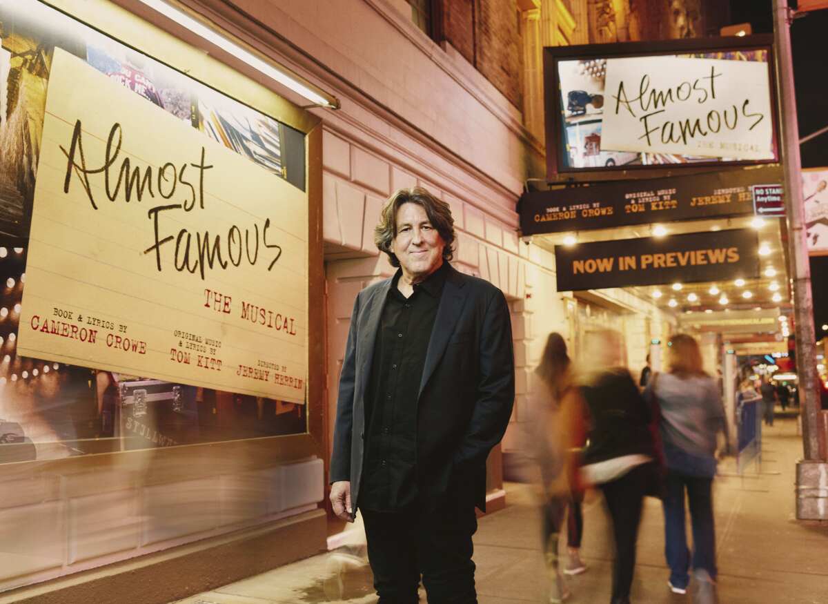 Cameron Crowe poses outside the the Bernard B. Jacobs Theatre in New York on Oct. 27, 2022. Crowe has turned his autobiographical coming-of-age film “Almost Famous” into a Broadway stage musical. The show, now in previews, opens Nov. 3. (Emilio Madrid via AP)