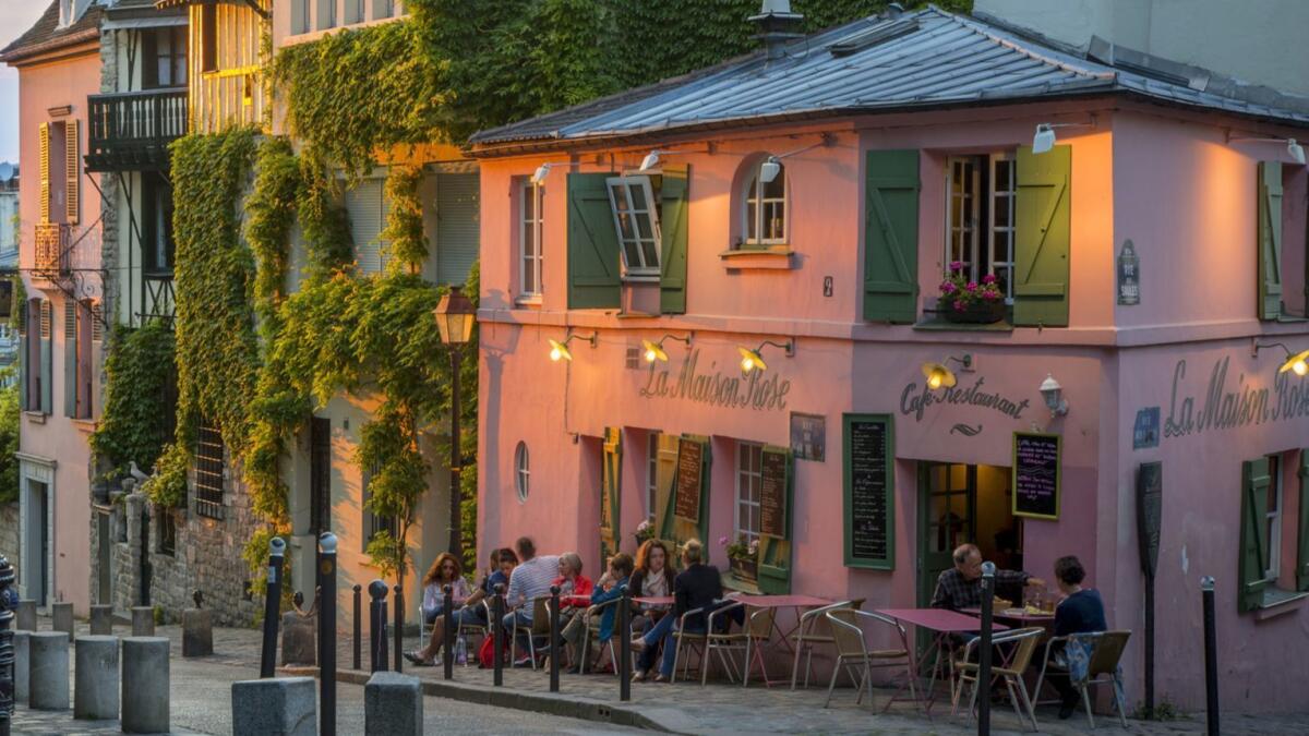 Evening sunlight on La Maison Rose in Montmartre, Paris. If you're eating out, eavesdrop a little and order what the person next to you is having.