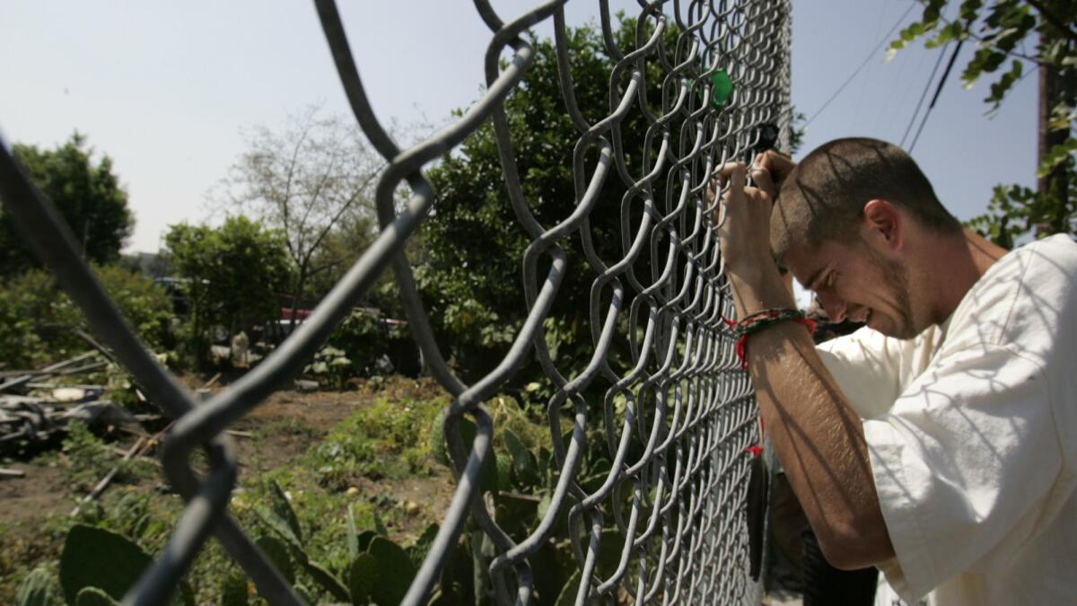 A protester weeps as bulldozing begins at the South Los Angeles site formerly known as "the Farm," where demonstrators and former farmers gathered to protest in 2006. They say a court ruling Thursday gives them fresh hope in their effort to block development of the site.