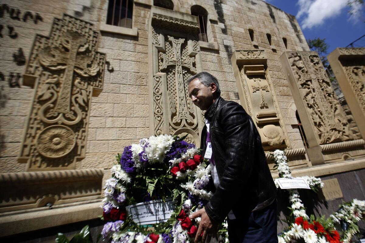 A member of the Armenian community lays a wreath Friday during a ceremony in Jerusalem's Old City commemorating the 100th anniversary of the mass killings of Armenians by Ottoman Turks in 1915.