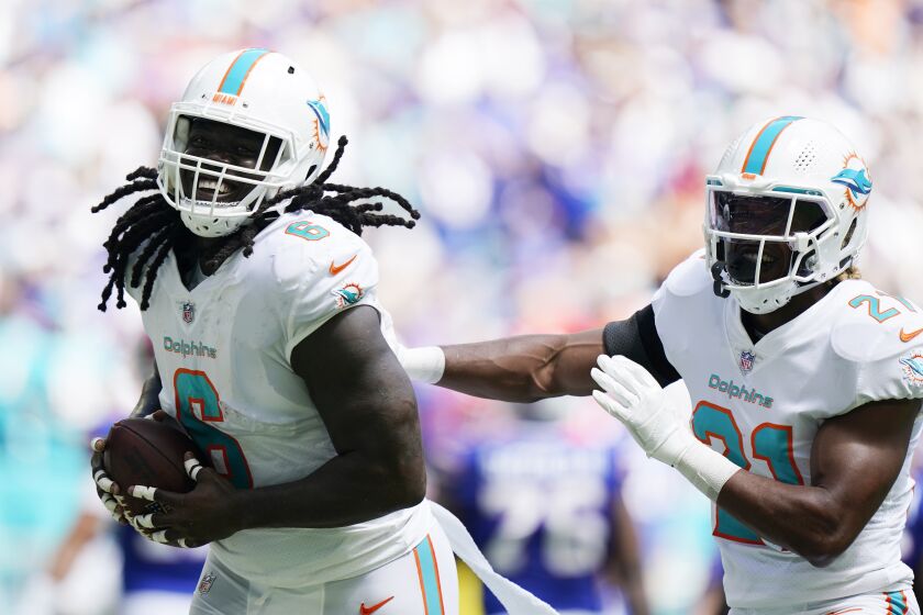 Miami Dolphins linebacker Melvin Ingram (6) celebrates after recovering a fumble during the first half of an NFL football game against the Buffalo Bills, Sunday, Sept. 25, 2022, in Miami Gardens, Fla. (AP Photo/Wilfredo Lee )
