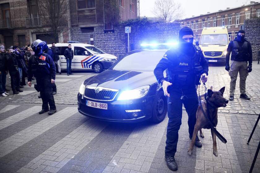 Policemen block a road near the scene of a police raid in the Molenbeek-Saint-Jean district in Brussels as part of the investigation into the November attacks in Paris. The main suspect in the jihadist attacks on Paris, Salah Abdeslam, was arrested in the raid.
