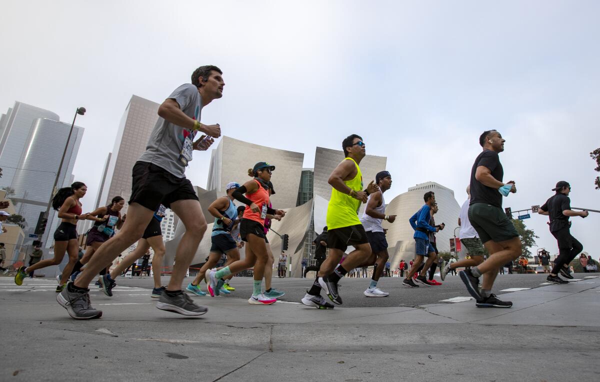 Runners near Disney Concert Hall in downtown Los Angeles