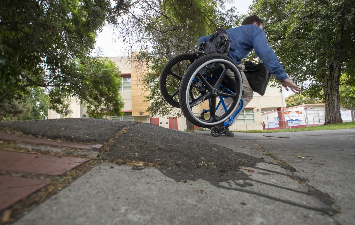 David Radcliff tumbles over a section of broken sidewalk