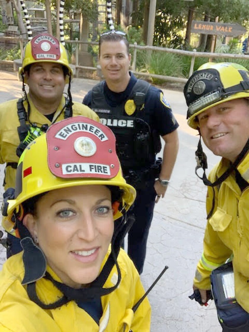 Nick Naiman, right, participates in a live reenactment of an active shooter situation at San Diego Zoo Safari Park on Oct. 23. More than 300 pretend victims participated in the training scenario. With him are Cal Fire engineers Shavawn Johnson, front left, and Joe Thompson with an Escondido police officer.