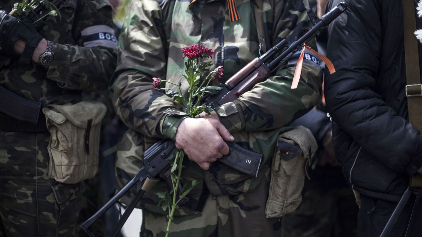 A pro-Russian gunman holds his machine gun and a flower during the commemoration of Victory Day in Donetsk, Ukraine on May 9. Victory Day honors the armed forces and the millions who died in World War II. This year it comes as Russia is locked in the worst crisis with the West, over Ukraine, since the end of the Cold War.