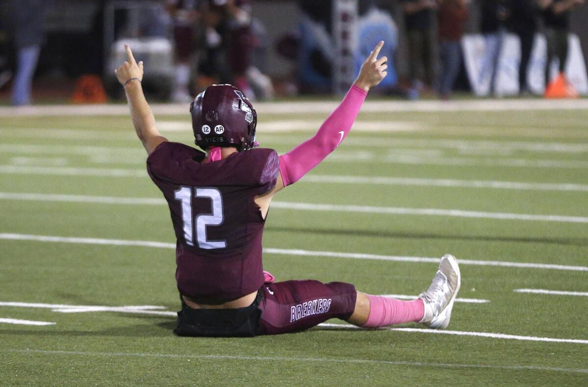 Quarterback Jackson Kollock (12) of Laguna Beach celebrates a touchdown all alone after a catch and run on Friday night.