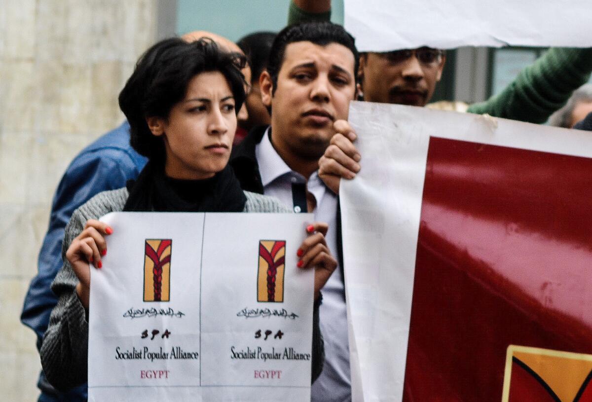 Shaimaa Sabbagh, 32, holds a poster during a protest in downtown Cairo on Jan. 24. A police lieutenant was convicted in her shooting death during a protest.