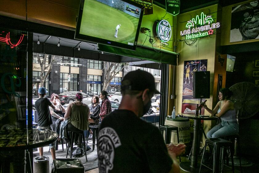 Los Angeles, CA, Sunday, June 28,2020 - Patrons of the Down'n'Out Sports Bar, drink at an outside patio. Governor Newsom orders bars to close as Covid-19 cases surge in California. (Robert Gauthier / Los Angeles Times)