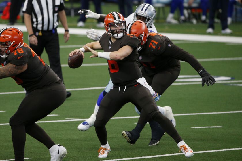 Cleveland Browns quarterback Baker Mayfield (6) looks to pass the ball during the second half of an NFL football game against the Dallas Cowboys in Arlington, Texas, Sunday, Oct. 4, 2020. (AP Photo/Michael Ainsworth)