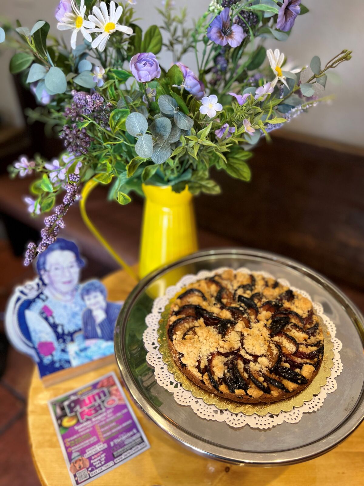 A fresh plum tart next to a photo of Elly Schwarzer and Dolores Bischof, who inspired Huntington Beach's annual Plum Fest.