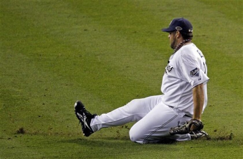 National League's Heath Bell of the San Diego Padres slides into the infield before pitching during the eighth inning of the MLB All-Star baseball game Tuesday, July 12, 2011, in Phoenix. The National League won 5-1. (AP Photo/Ross D. Franklin)