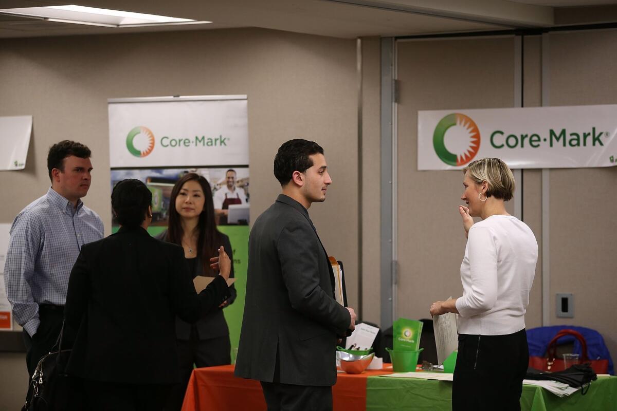 Job seekers meet with recruiters during a June 4 career fair in San Francisco.