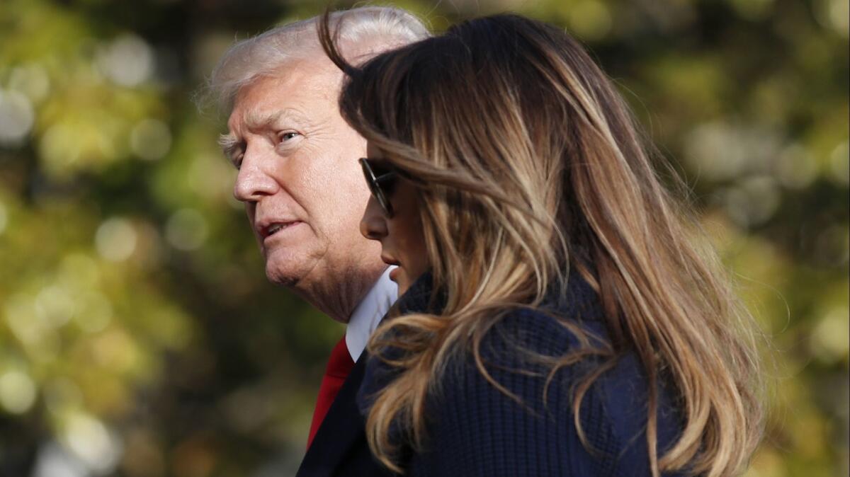 In this March 19, 2018, photo, President Donald Trump, accompanied by first lady Melania Trump, walks on the South Lawn of the White House in Washington, on his return from a trip to New Hampshire. Former Playboy model Karen McDougal apologized to Melania Trump for a 10-month affair she claims she had with President Trump that started with him offering her money after the first time they had sex. (AP Photo/Alex Brandon)