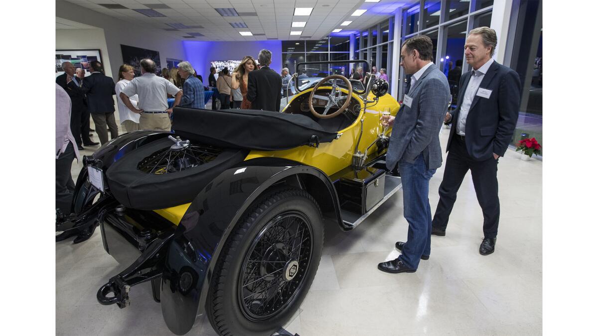 Russ Petrie, left, and James Caillouette look at a 1920 Stutz Model H Bearcat during the Dec. 7 grand opening of Morris & Welford. The 15,000-square-foot showroom features unique, rare, vintage and classic cars.