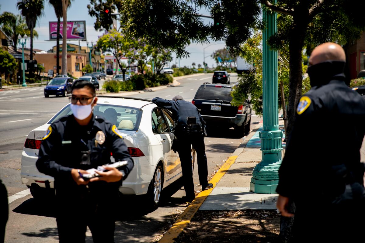 San Diego Police Department officers make a traffic stop along El Cajon Boulevard on June 23, 2020.